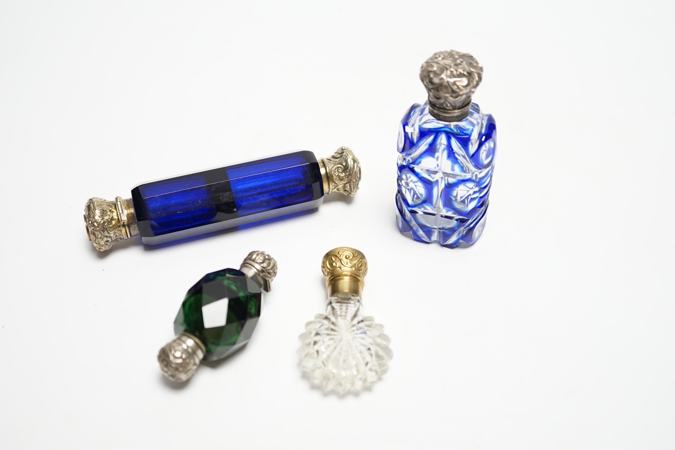 Four assorted Victorian white or gilt metal mounted cut glass scent bottles, including double ended blue glass scent bottle, 12.2cm.